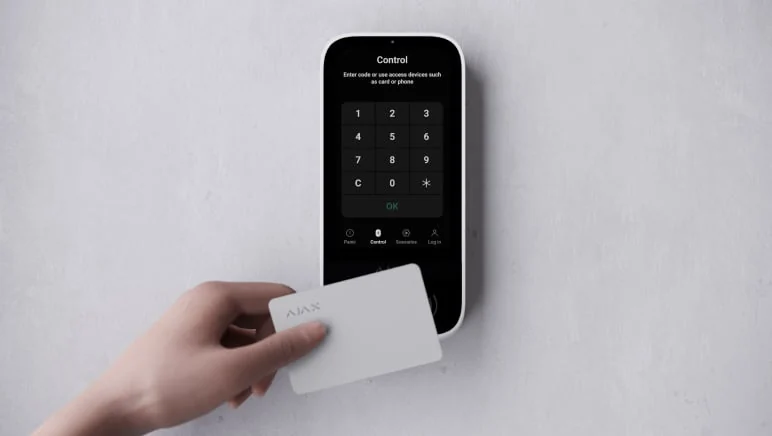 Ajax touchscreen keypad on a wall, set with an access card