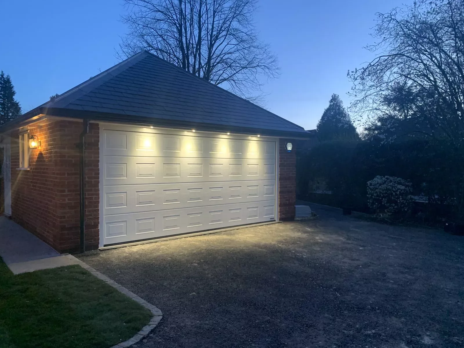 Detached garage and driveway at dusk