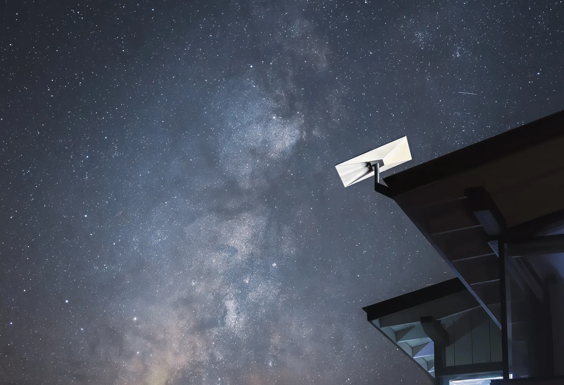 Starlink installation in Cork: a Starlink dish on a roof eave under a starry night sky